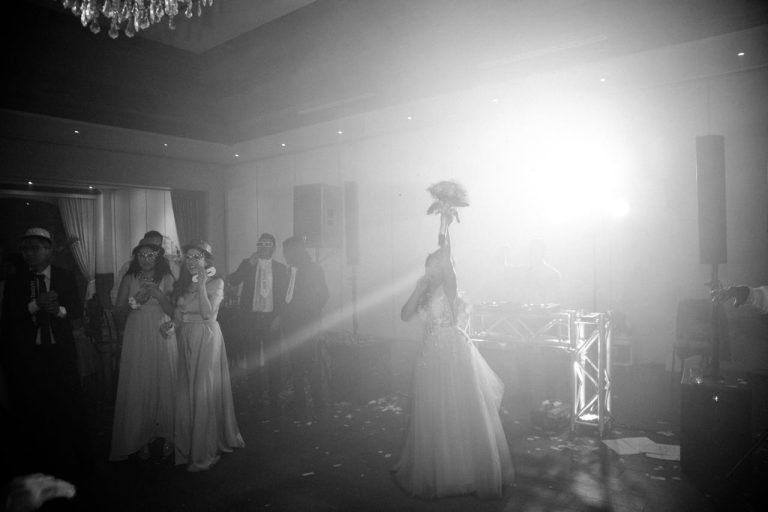 Bride tossing the bouquet to cheering guests