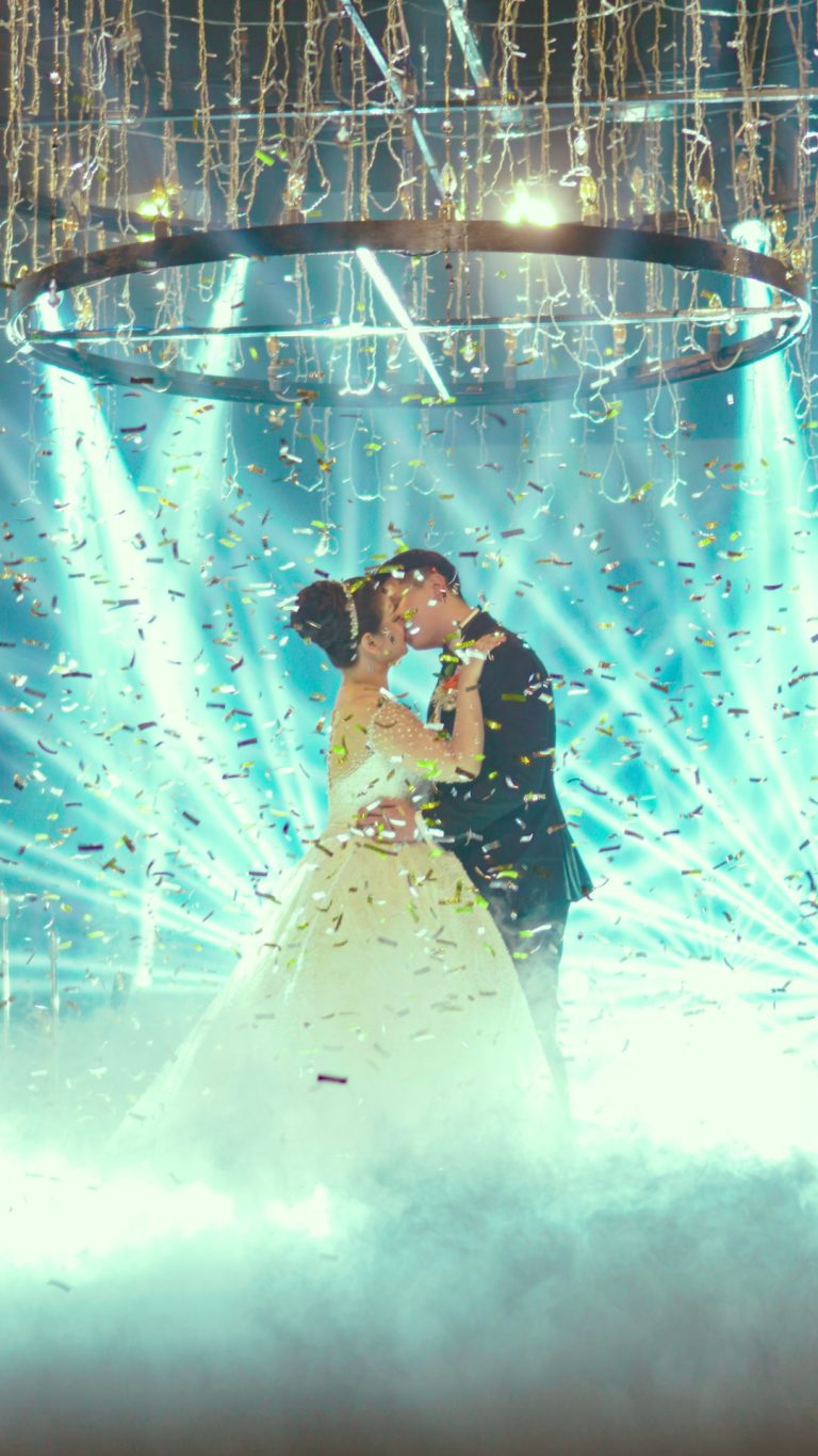 First dance under lights and haze at a wedding