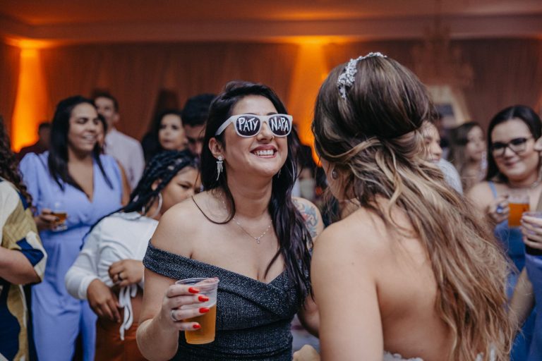 Bride dancing and laughing with friends at her wedding reception