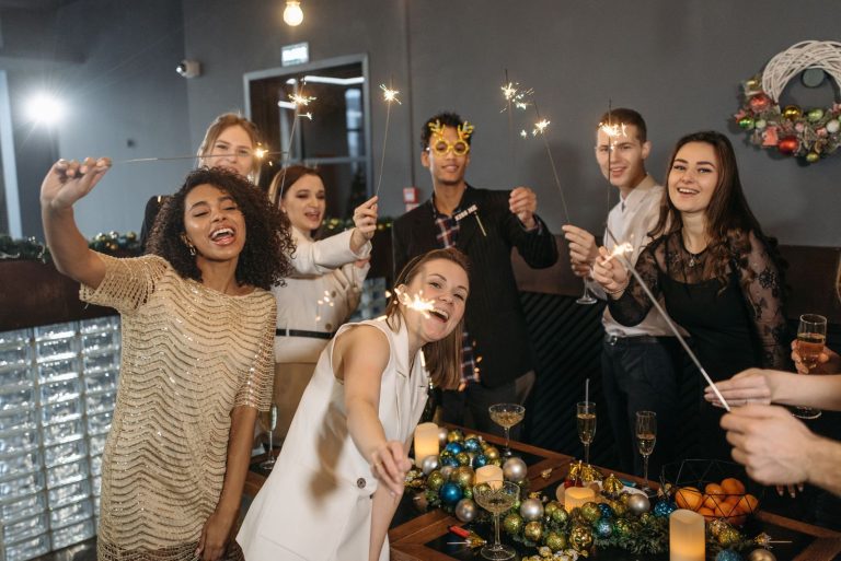 Team celebrating with sparklers at a corporate holiday party